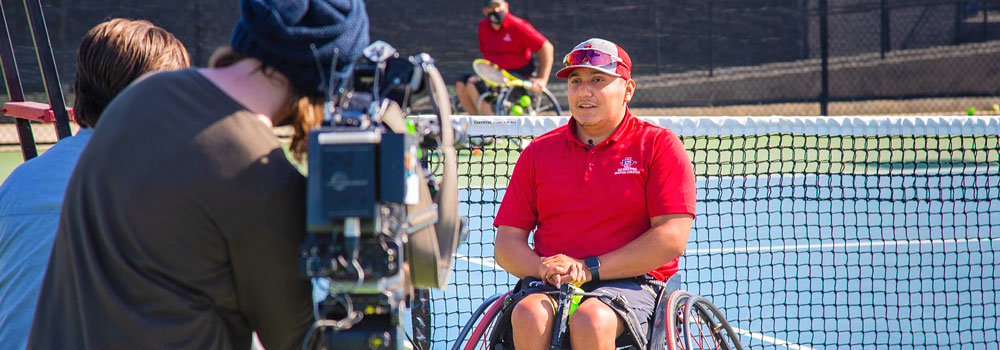 Wheelchair Tennis Athlete being interviewed on camera at Aztec Tennis Court